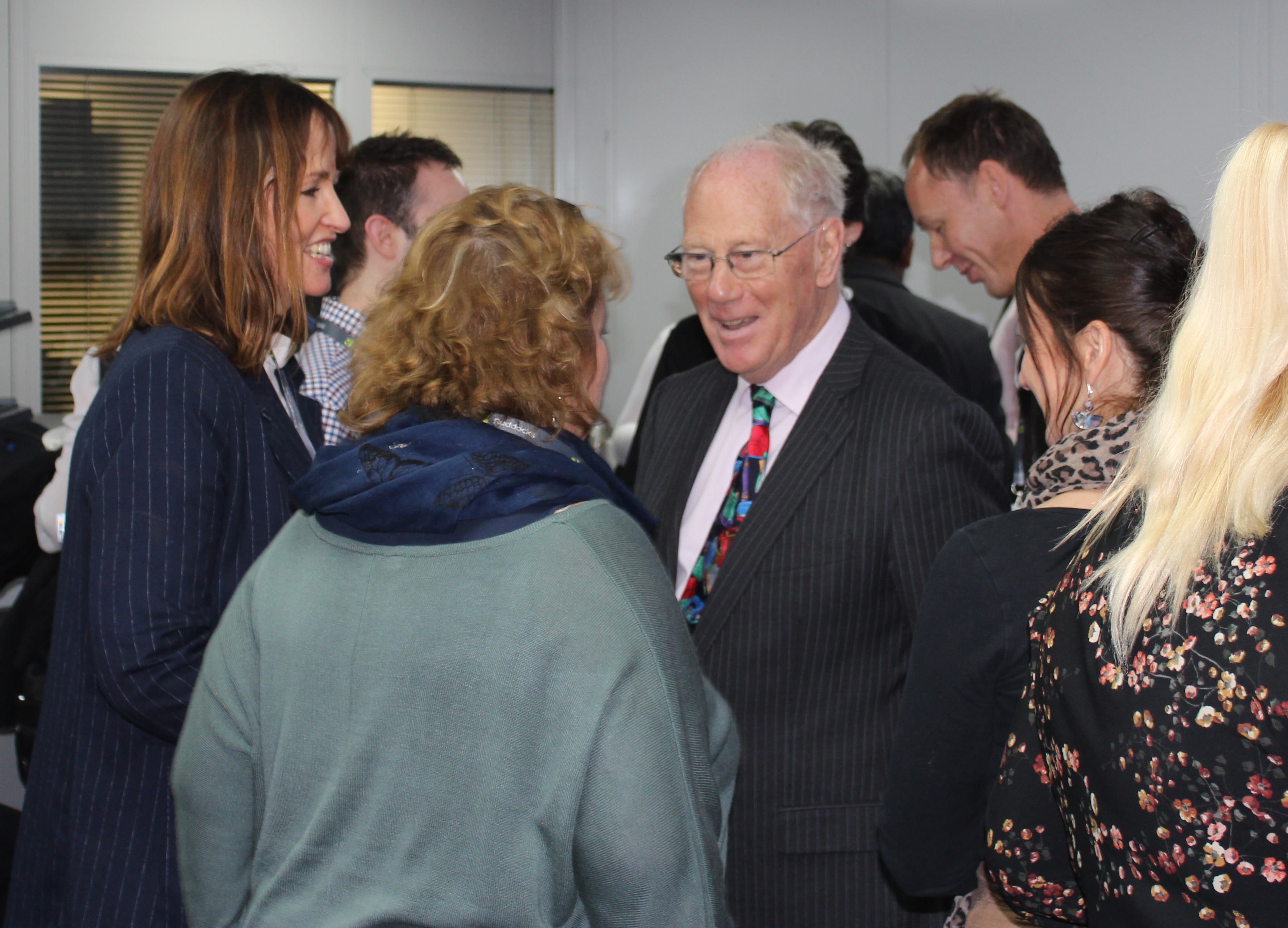 Group of people mingling and talking at a networking event