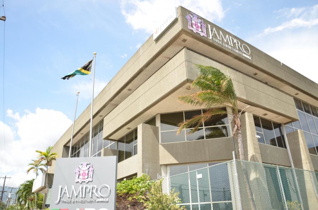 Picture of a light coloured building with Jamaican flag and signage JAMPRO