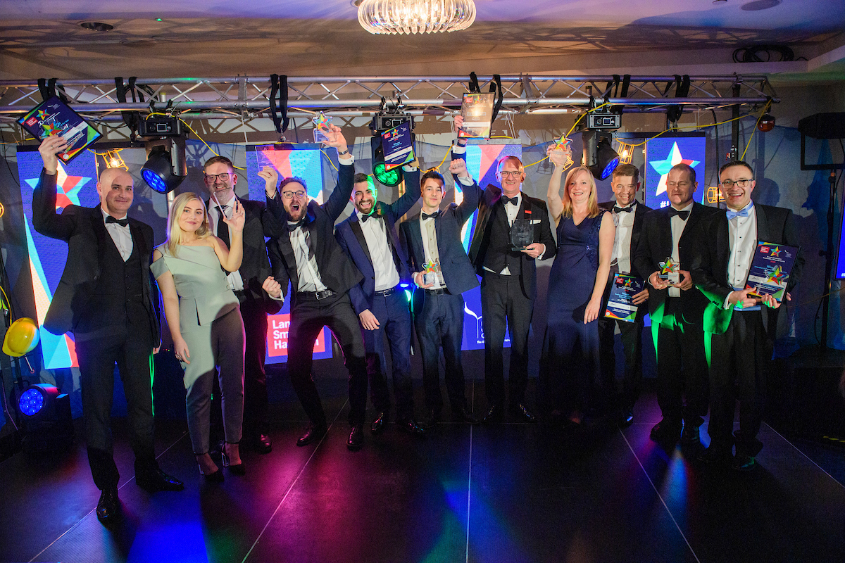 Picture of a group of men and women in formal evening wear holding trophies and celebrating at The Greater Lincolnshire Construction and Property Awards 2020