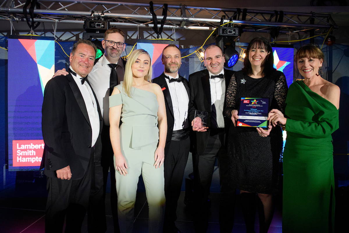 Group of people wearing eveningwear holding trophy and certificate smiling at The Greater Lincolnshire Construction and Property Awards 2020