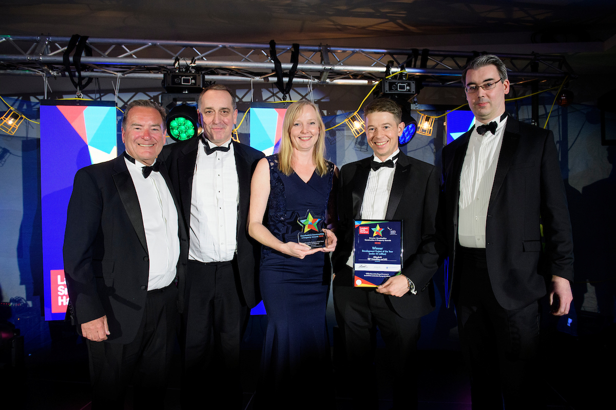 Group of people wearing eveningwear holding trophy and certificate smiling at The Greater Lincolnshire Construction and Property Awards 2020