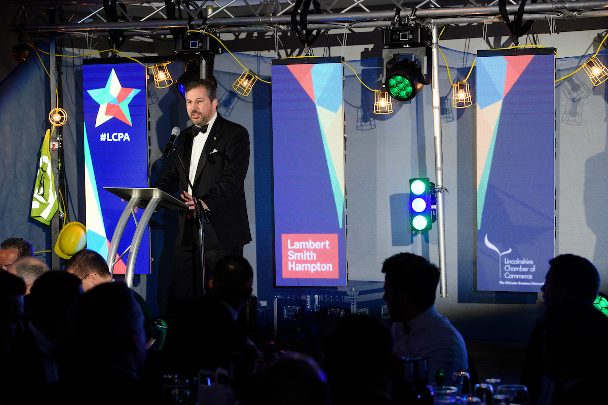 Gary Headland, Chair of the Lincolnshire Chamber of Commerce, wearing formal eveningwear on stage at The Greater Lincolnshire Construction and Property Awards 2020