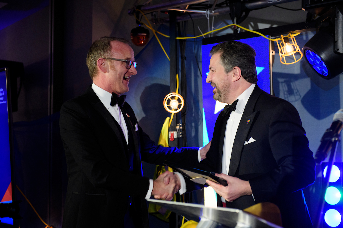 Two men in eveningwear, Tim Downing and Gary Headland, shaking hands at The Greater Lincolnshire Construction and Property Awards 2020