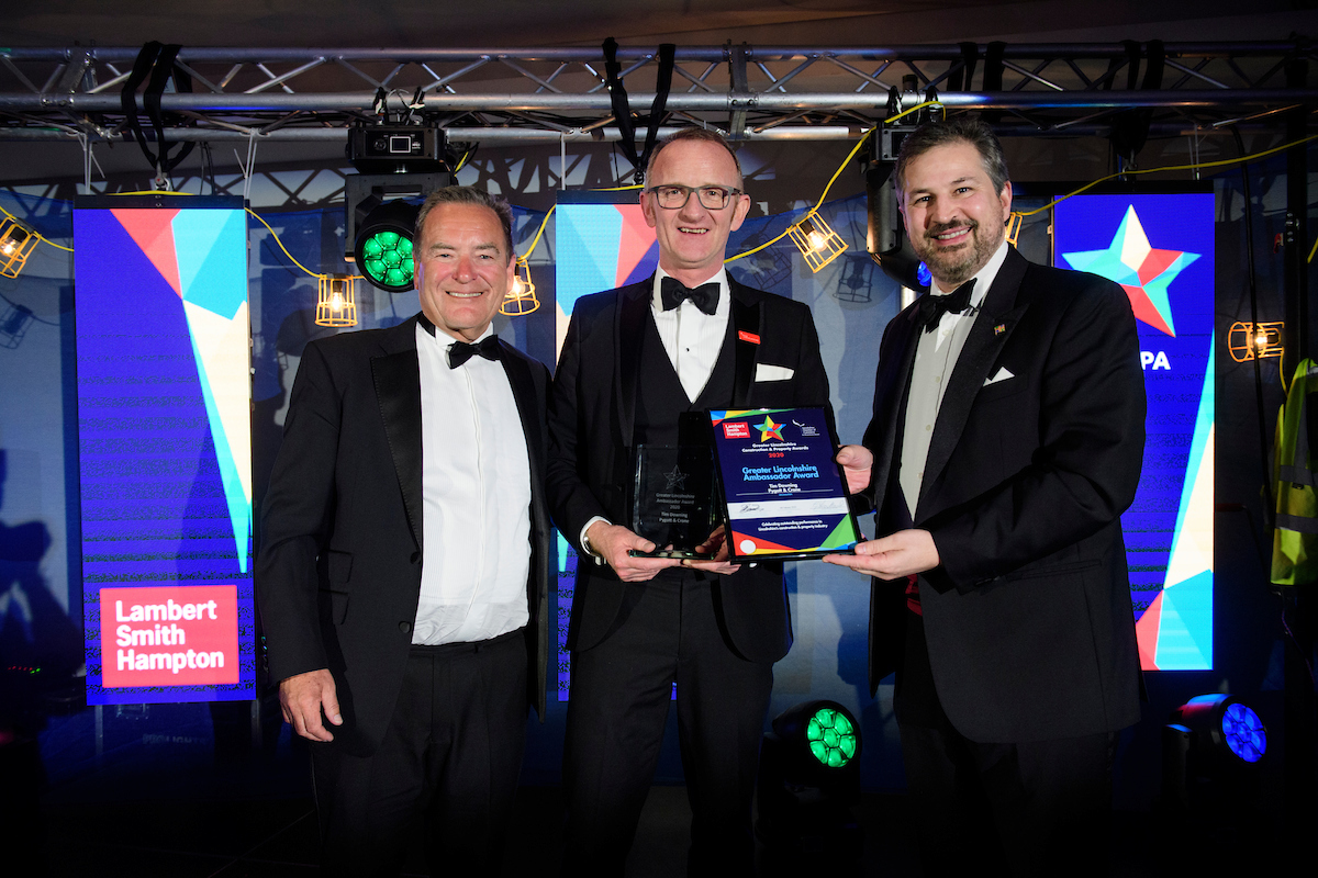 Three men in eveningwear smiling and posing with certificate and trophy at the Greater Lincolnshire Construction and Property Awards 2020