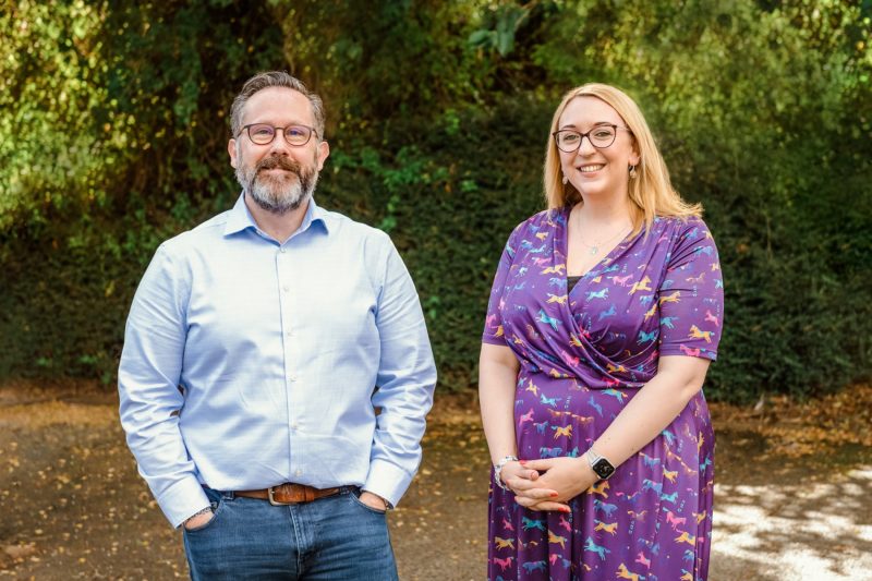 A man and a woman smiling at the camera