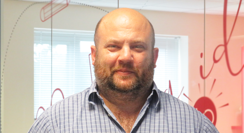 A man in blue button-up shirt with pattern