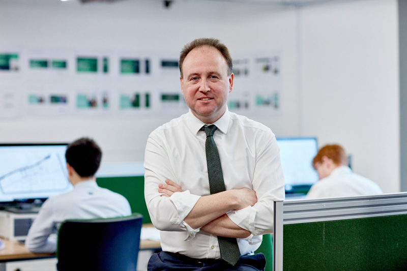 Lee Marshall of Viridis building services, a man in white shirt and dark tie in office setting