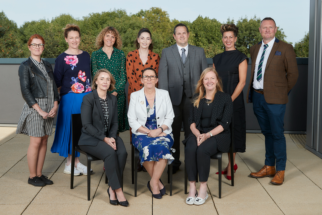 Group of men and women sitting and standing posing, they are the new Greater Lincolnshire LEP Visitor Economy Board