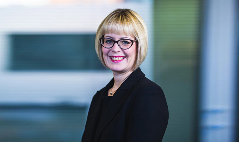 Louise Bush, partner at Sills & Betteridge LLP in Lincoln, a woman with short blonde hair, dark glasses, black clothing, smiling