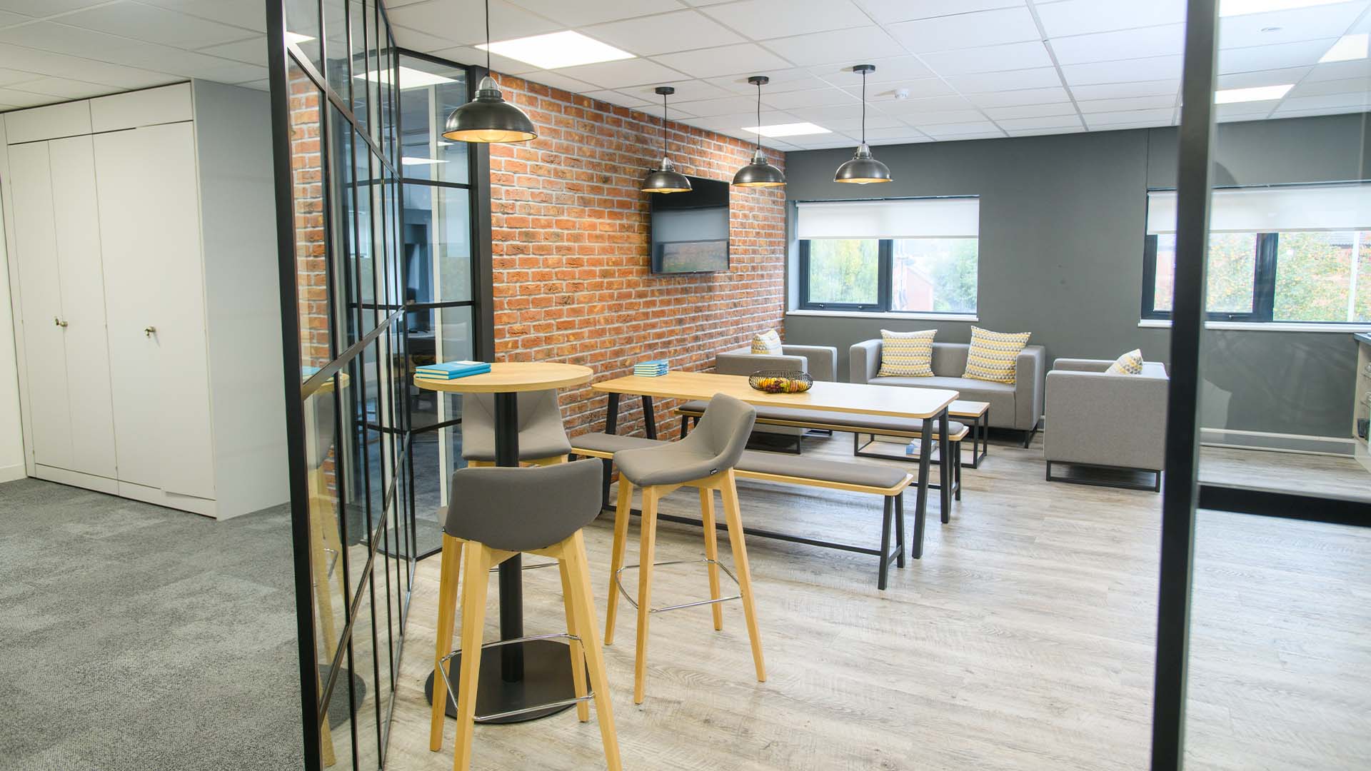 A modern office space with multiple chairs and tables.