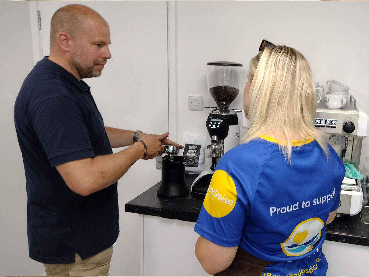 Two People making a coffee.