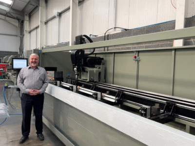 A man standing next to a large machine. 