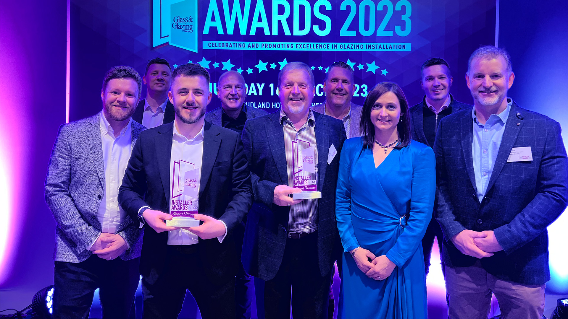 A large group of people, posing for an awards photo.